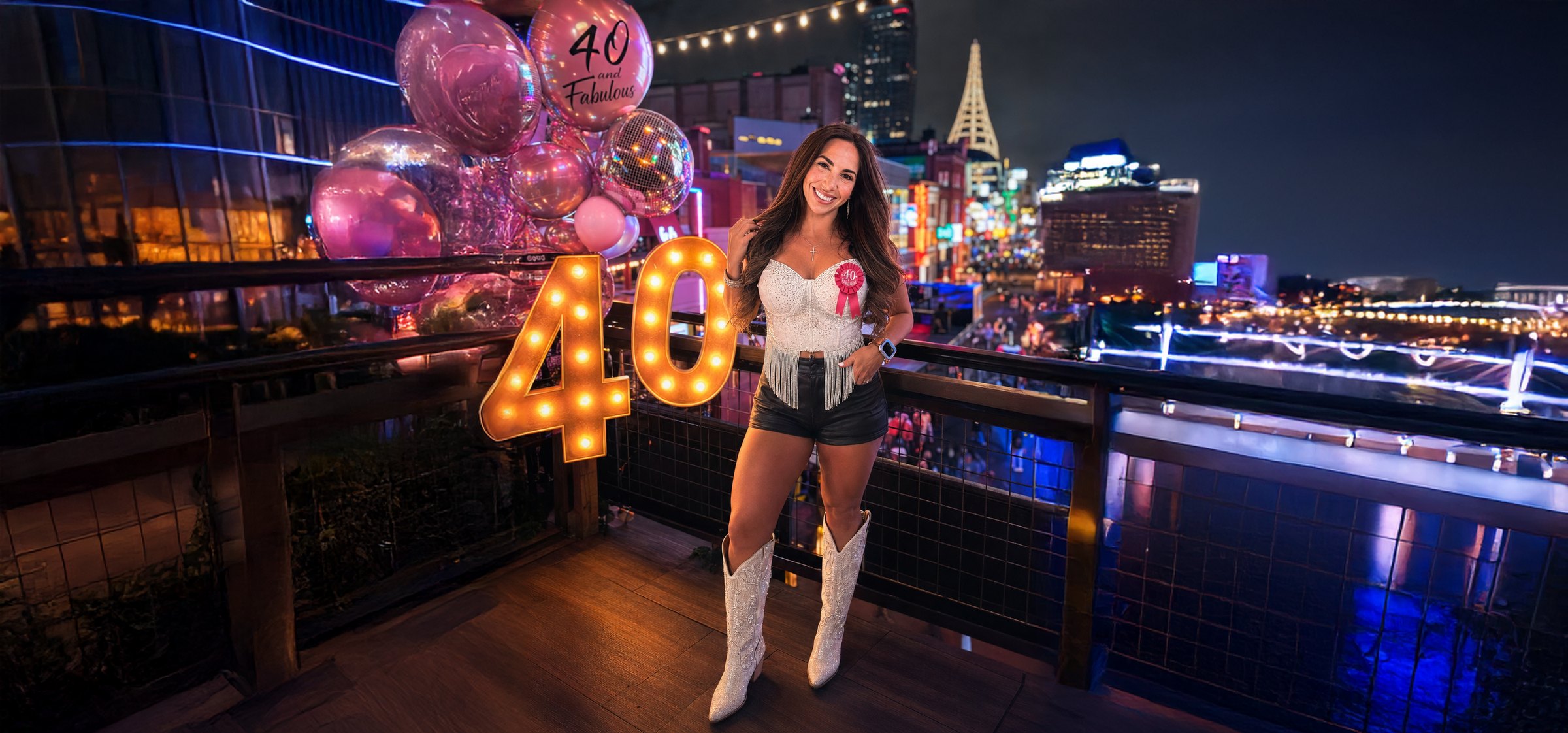 Jess on a Nashville rooftop with marquee 40 letters, pink 40 balloons, and Nashville skyline